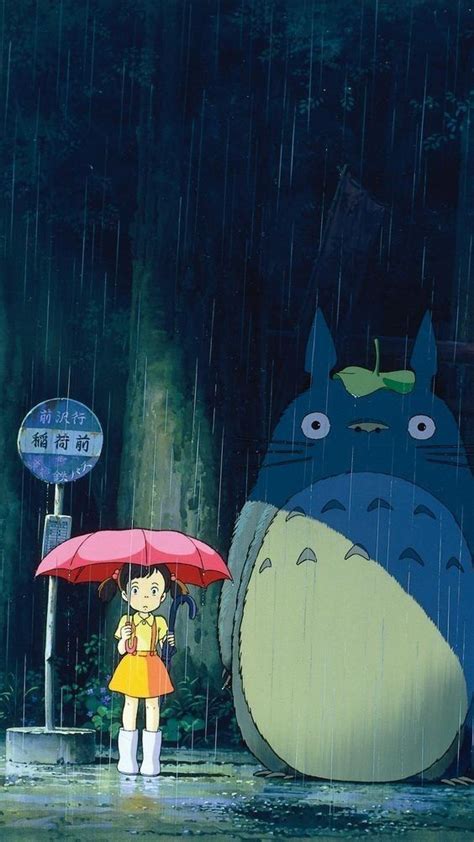 A Person Holding An Umbrella Standing In The Rain With A Totoro Behind Them