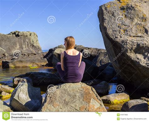 Girl Practices Yoga Near The Sea On The Rock Slow Motion Hd Video
