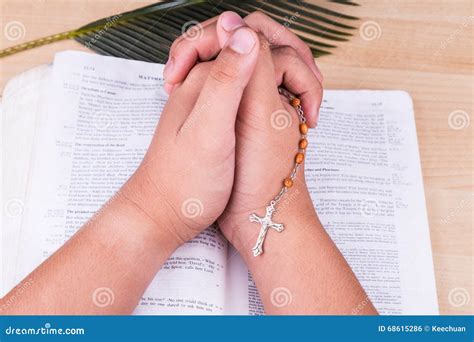 Reciting Prayers Using Catholic Rosary With Crucifix And Bible Stock