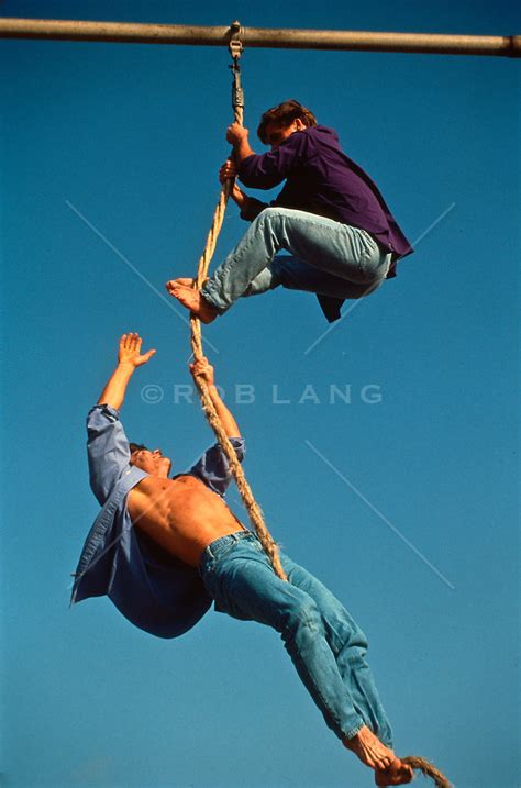Two Men Playing Around On A Rope ROB LANG IMAGES LICENSING AND