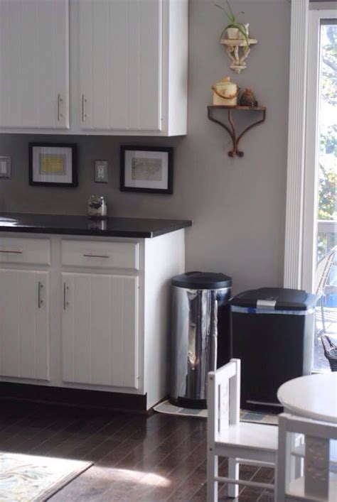 The color of these kitchen cabinets is lunar grey, and it works so well with brass hardware. White cabinets, light gray walls, dark gray countertops ...