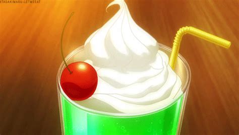 A Green Drink With Whipped Cream And A Cherry On The Top Sitting On A