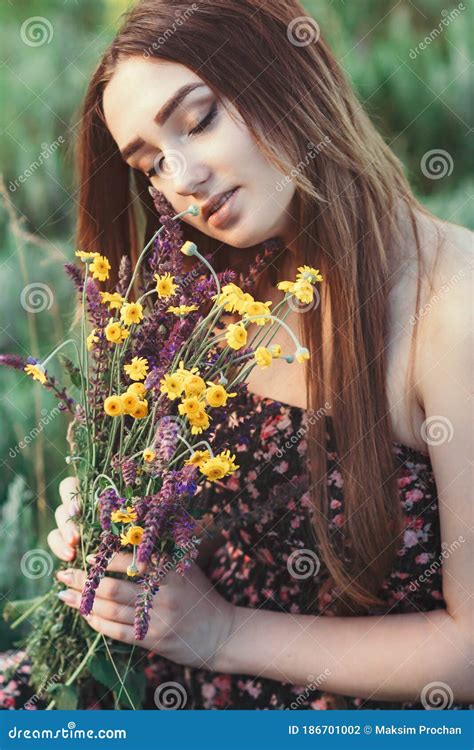 Beautiful Girl With Bouquet Of Wildflowers On Meadow Young Woman With Long Hair In Dress