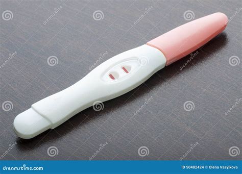 A Positive Pregnancy Test Strip And An Ultrasound Image Of The Fetus