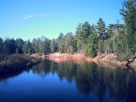 A Body Of Water Surrounded By Lots Of Trees