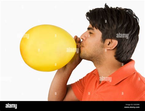 Man Blowing Up A Balloon Stock Photo Alamy