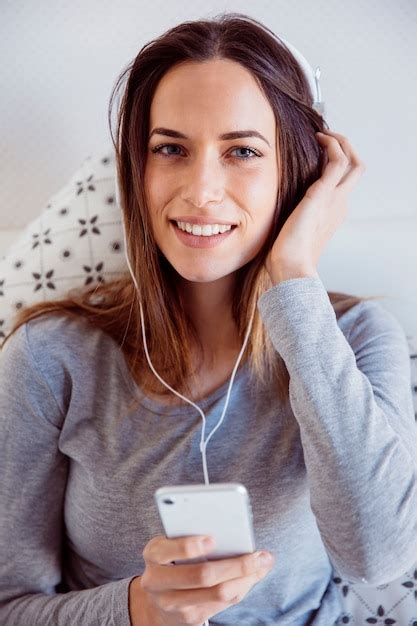Free Photo Cheerful Woman Listening To Music In Bed
