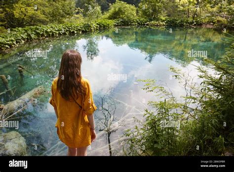 Woman Enjoying View Of Waterfalls And Lakes In Plitvice National Park