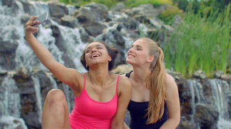 Female Friends Taking Selfie Near Waterfall Multiracial Girls Taking