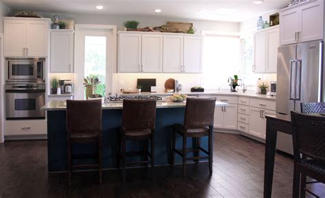 Standing 63'' tall, its frame is constructed from wood. white cabinets and deep teal kitchen island | Teal kitchen ...
