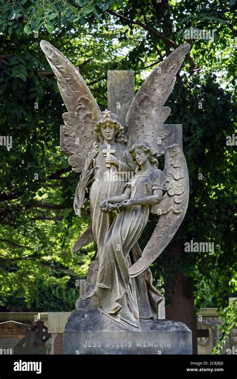 Memorial With Two Angels One Holding A Cross The Other A Wreath In The