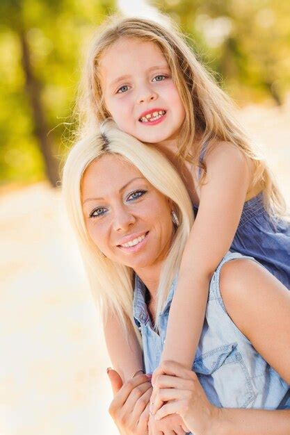 Premium Photo Beautiful Happy Mother And Daughter Hugging In The Park