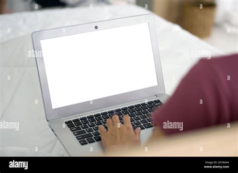 Back View Of Woman Typing On Laptop Computer Keyboard With White Screen