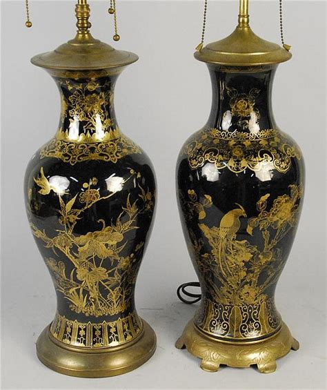 lot two similar chinese porcelain gilt decorated black ground vase form lamps on gilt metal