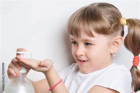 Foto Stock Girl Squirts Soap Into Hands Adobe Stock