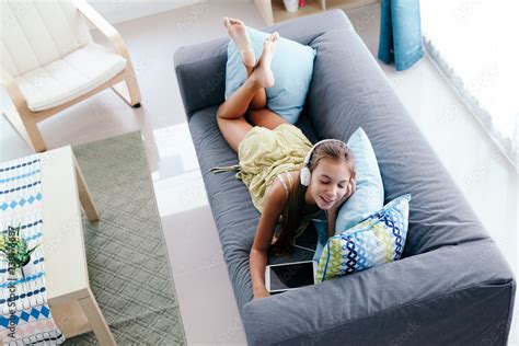 Tween Girl Relaxing On Couch At Home Stock Photo Adobe Stock