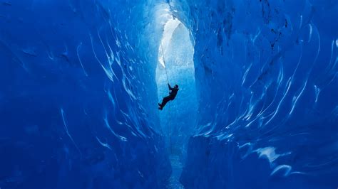 A Climber Rappels Into An Ice Cave On The Mendenhall Glacier Alaska
