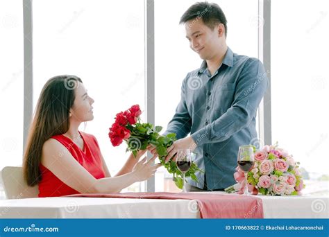 Man Giving Red Rose Bouquet With Woman Stock Photo Image Of