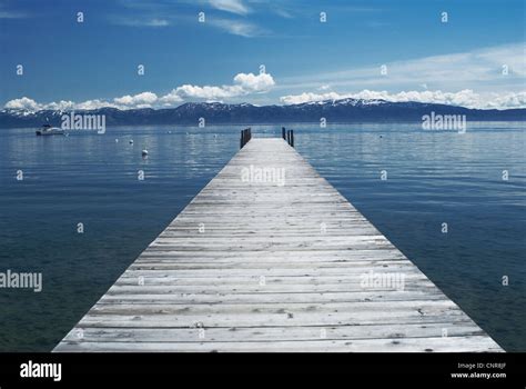 Wooden Dock In Still Lake Stock Photo Alamy