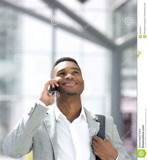Young African American Man Smiling With Mobile Phone Stock Image