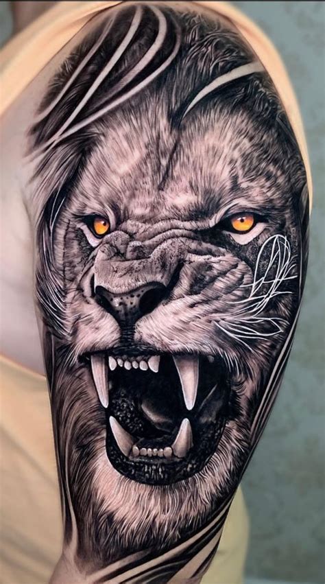 A Man S Arm With A Lion Tattoo On It And An Orange Eyed Eye