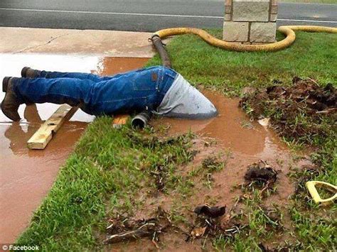 Professional Plumber Dips Head Inside Mud To Fix A Leaking Pipe