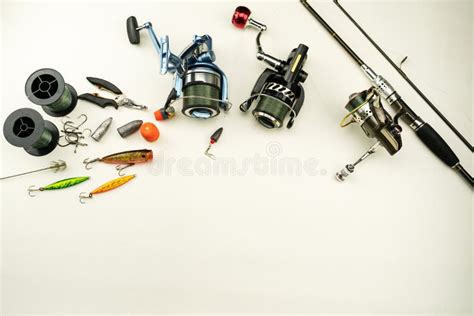 Fishing Rods And Reels Fishing Tackle On White Leather Background Stock