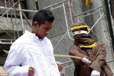 Indonesian Women Wait To Be Whipped In Front Of A Baying Crowd For