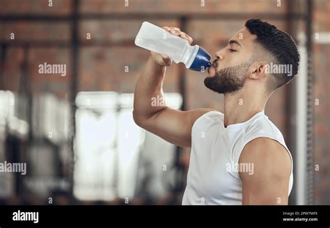Man Taking A Break From Exercise To Hydrateyoung Man Drinking Water