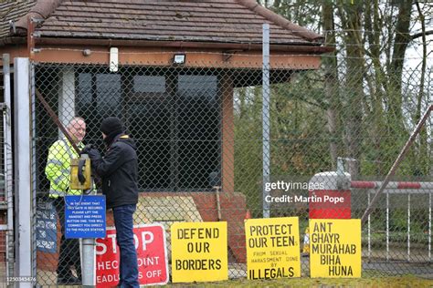 Security Staff At The Main Gate Of The Former Air Base Talk To A