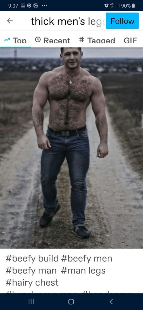 A Man Standing In The Middle Of A Dirt Road With His Shirt Off And No