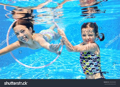 Стоковая фотография 256335460 Happy Children Swim Pool Underwater