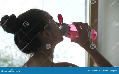 Young Caucasian Woman Quenching Her Thirst Female Drinks Water From