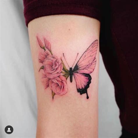 A Woman S Arm With A Pink Flower And Butterfly Tattoo On The Left Side