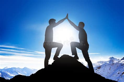 Male Friends Giving High Five On Mountain Peak Stock Photo Image Of