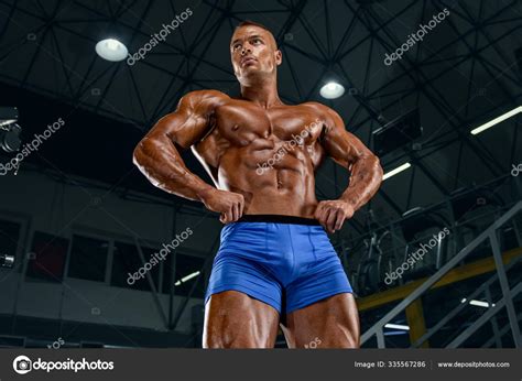 Strong Muscular Handsome Men Flexing Muscles In The Gym Bodybuilder