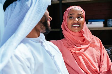 Happy Middle Eastern Couple Wearing Traditional Arab Clothing At Home