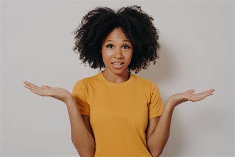 Confused Doubtful Black Woman Shrugging With Shoulders Feeling Baffled