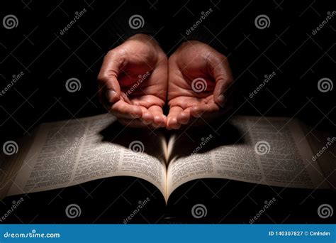 African American Man Praying With Hands Open On Top Of The Bible Stock