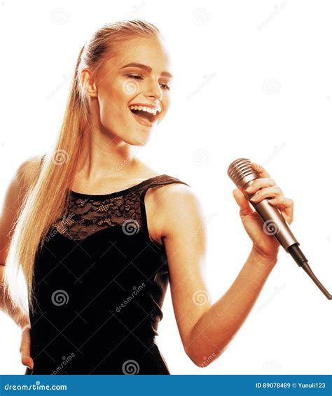 Young Pretty Blond Woman Singing In Microphone Isolated Close Up Stock