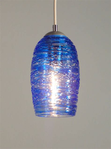 blue glass light with spun glass exterior hand blown glass lighting made in usa in 2022