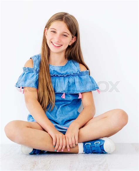 Girl Sitting On Floor With Legs Crossed Stock Image Colourbox