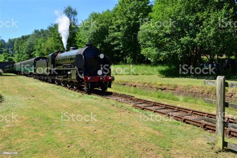 Vintage Steam Train Emerging From A Tunnel On A Heritage Railway Line