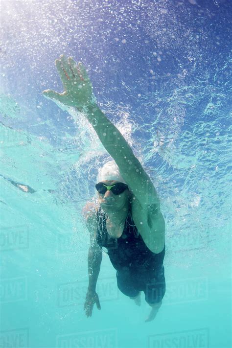 Male Swimmer Athlete Swimming Underwater In Swimming Pool Stock Photo