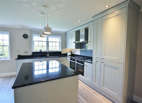 A white kitchen with black granite can work for a variety of design styles and provide excellent contrast and visual interest. Partridge Grey units with Black granite worktops, up ...