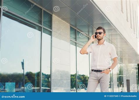 Young Thoughtful Businessman Making A Phone Call Outdoors Stock Image