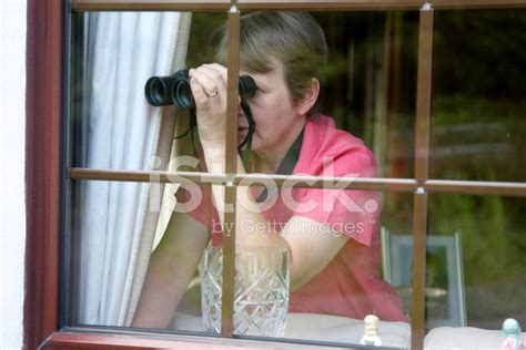 Nosey Neighbour At The Window With Binoculars Stock Photo Royalty