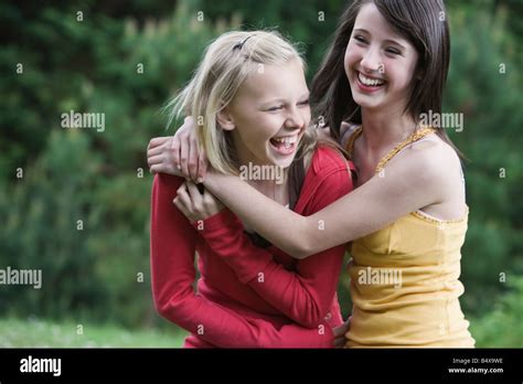 Girls Laughing In Park Stock Photo Alamy