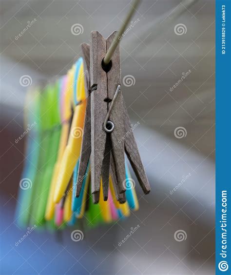 Mixture Of Plastic And Wooden Clothes Pegs Hanging From A Clothes Line