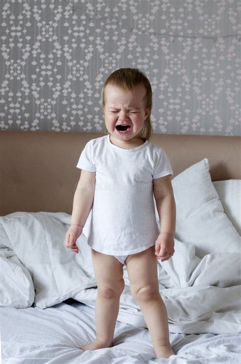 Baby Screaming And Crying In Bed Tantrums And Whims Of Children Stock